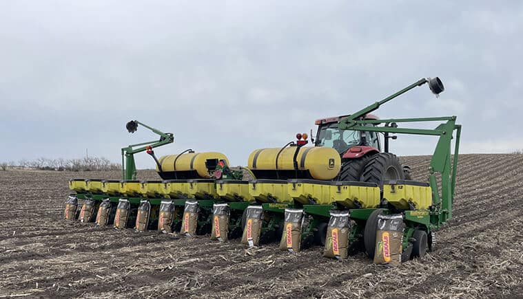 tractor with planter and seed bags in field